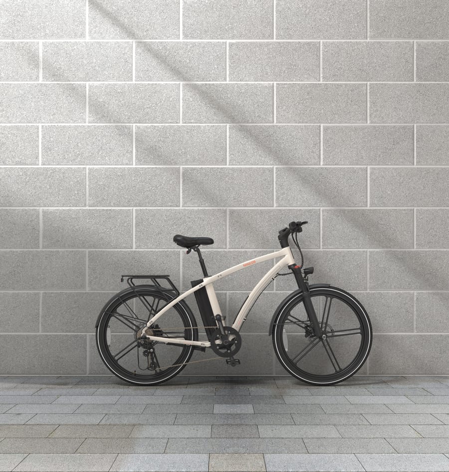 White NINE09 electric bike parked against a concrete block wall